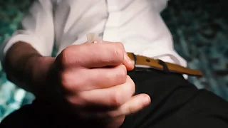 Sexy guy in a suit jerks off close-up, moans with pleasure and cums in a condom.